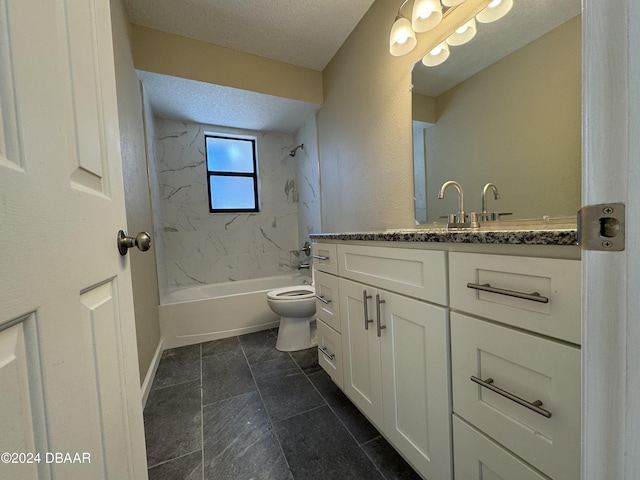 full bathroom with vanity, a textured ceiling, toilet, and tiled shower / bath combo