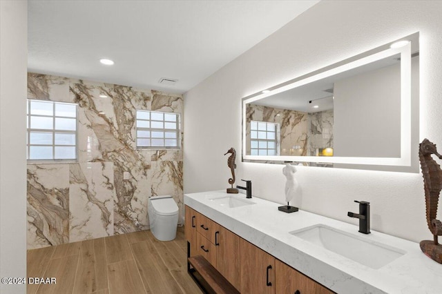 bathroom featuring vanity, hardwood / wood-style flooring, a shower, and toilet