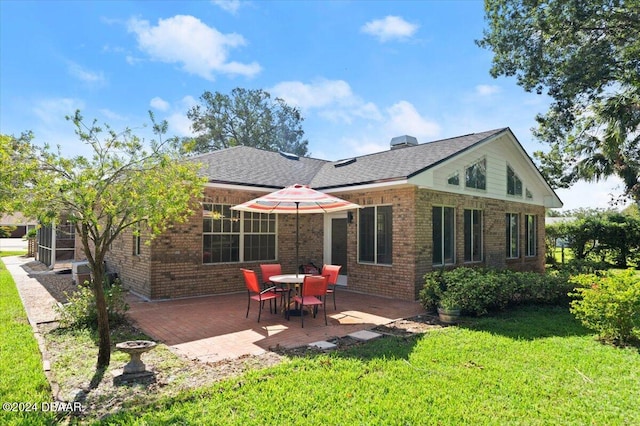 back of property featuring a lawn and a patio