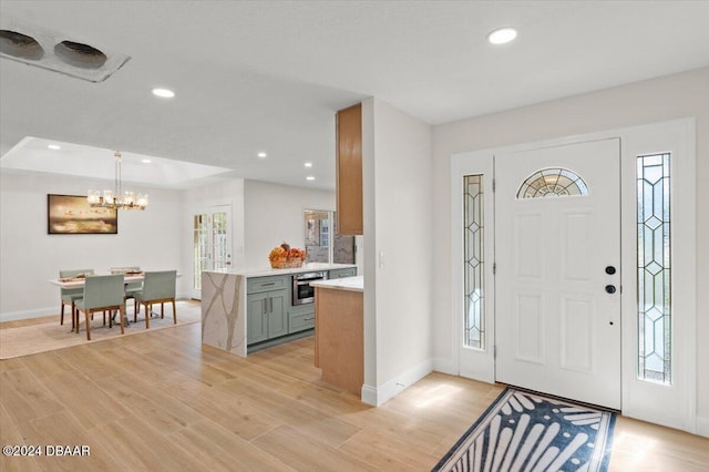 foyer featuring a chandelier and light wood-type flooring