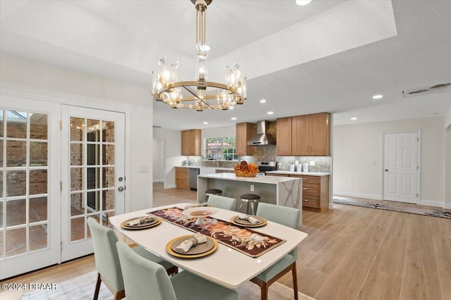 dining area with a chandelier and light hardwood / wood-style floors