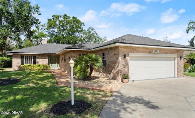 ranch-style house featuring a garage and a front yard