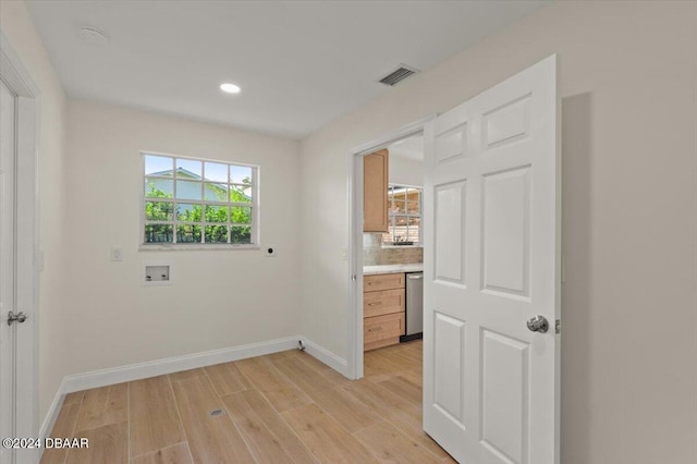 interior space with washer hookup, light hardwood / wood-style flooring, and electric dryer hookup