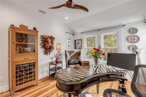 miscellaneous room featuring hardwood / wood-style floors, ceiling fan, and lofted ceiling