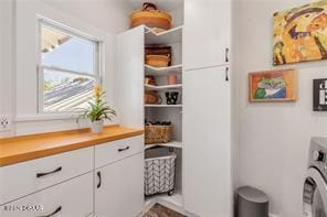 laundry room with cabinets and washer / dryer