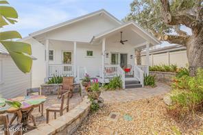 back of property featuring a porch, a patio, and ceiling fan