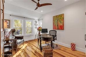 home office with hardwood / wood-style floors, vaulted ceiling, and ceiling fan