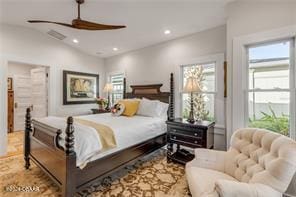 bedroom with ceiling fan, lofted ceiling, and multiple windows