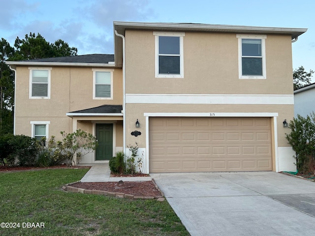 front facade with a front lawn and a garage