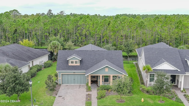 view of front of property with a garage and a front lawn