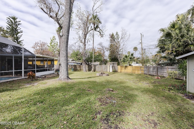 view of yard with glass enclosure