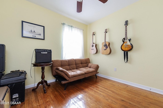 sitting room with wood-type flooring and ceiling fan