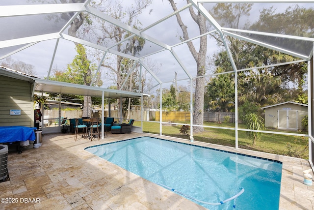 view of pool featuring a patio, a lanai, a shed, and a lawn