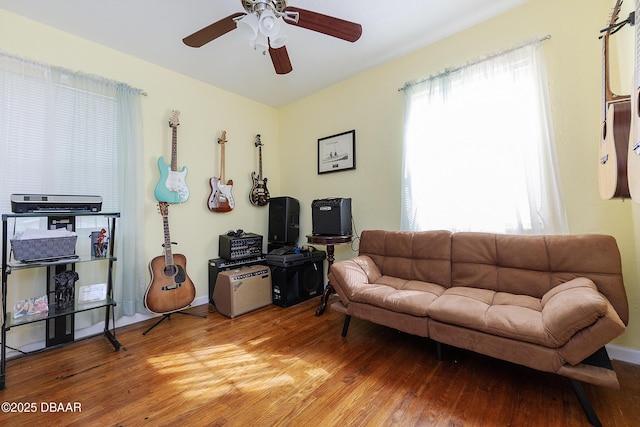 living room with ceiling fan and light wood-type flooring