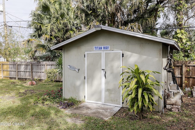 view of outbuilding with a yard