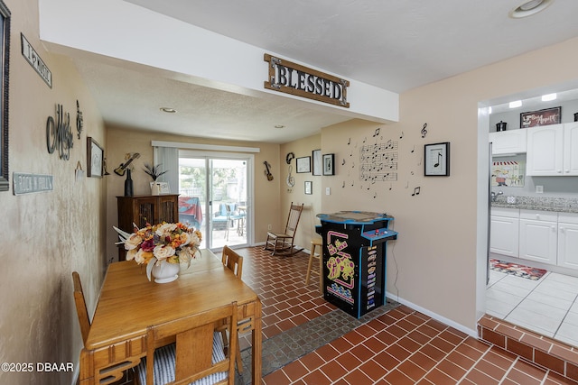 dining room with dark tile patterned flooring