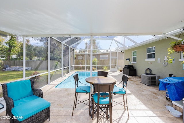 view of swimming pool with cooling unit, a lanai, and a patio