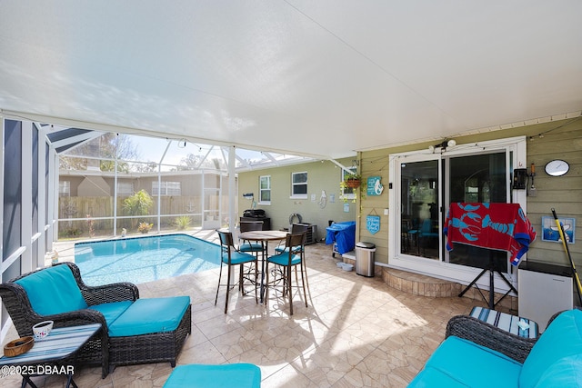 exterior space with outdoor lounge area, a patio, and glass enclosure