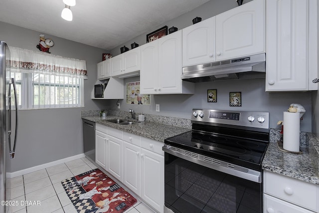 kitchen with appliances with stainless steel finishes, sink, white cabinets, and light stone counters