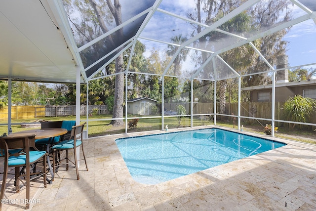 view of pool with a storage shed, a lanai, and a patio area