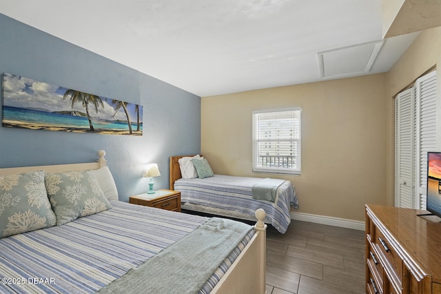 2626 S Atlantic Ave Unit 505, Daytona Beach, FL 32118 - bedroom featuring attic access, baseboards, a closet, and wood finished floors