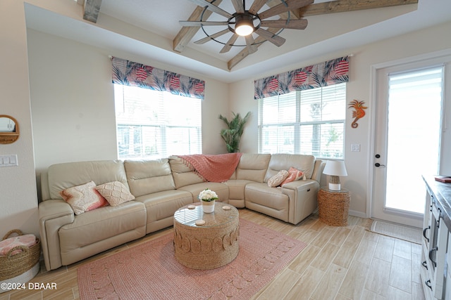 living room featuring ceiling fan, beamed ceiling, and light wood-type flooring