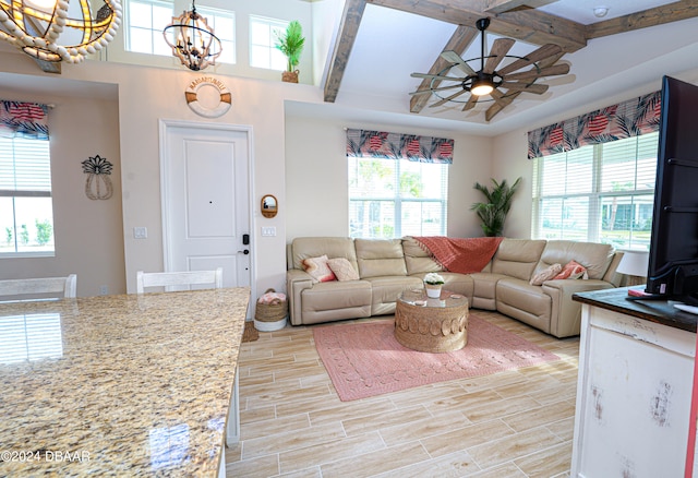 living room with beamed ceiling and plenty of natural light