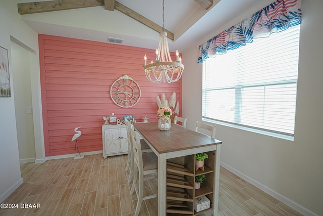 dining space featuring a chandelier, lofted ceiling with beams, light hardwood / wood-style flooring, and wood walls