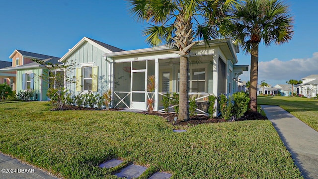 exterior space with a front lawn and a sunroom