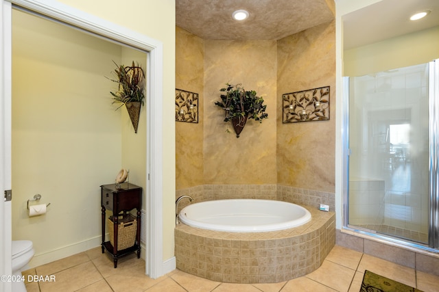 bathroom with tile patterned floors, independent shower and bath, and toilet