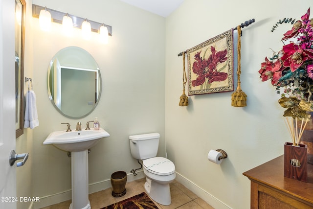 bathroom with toilet and tile patterned floors