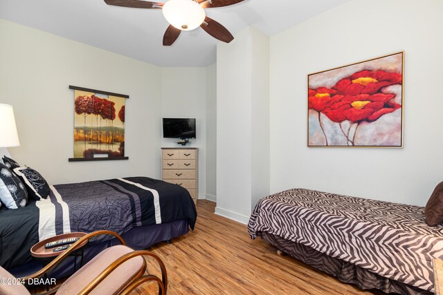 bedroom with ceiling fan and light wood-type flooring