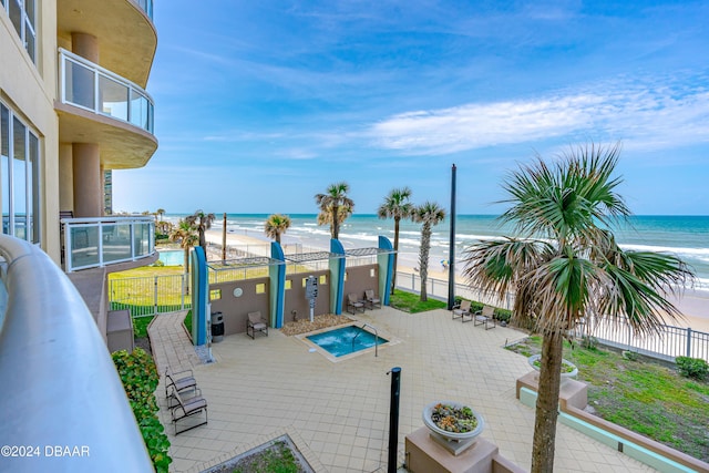 1925 S Atlantic Ave Unit 205, Daytona Beach Shores, FL 32118 - fenced backyard with view of water and beach, a balcony, a patio, and a community pool