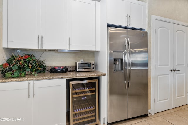 kitchen featuring white cabinets, stainless steel fridge with ice dispenser, and beverage cooler