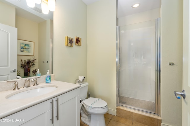 bathroom featuring tile patterned flooring, vanity, toilet, and an enclosed shower