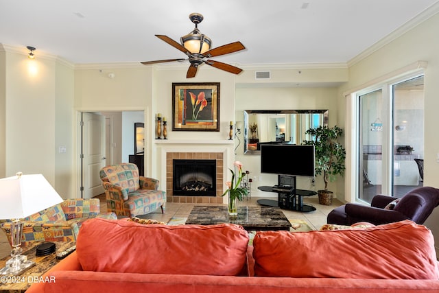 1925 S Atlantic Ave Unit 205, Daytona Beach Shores, FL 32118 - living room with crown molding, ceiling fan, a tiled fireplace, and tile patterned floors