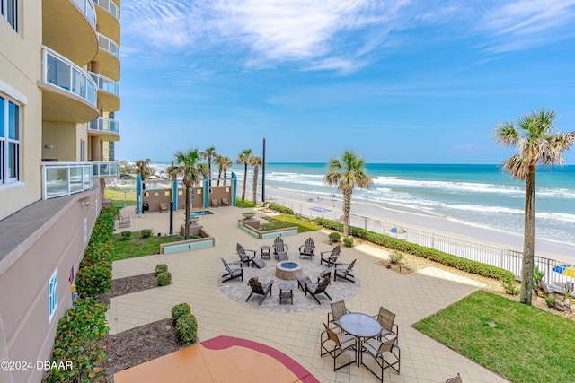 1925 S Atlantic Ave Unit 205, Daytona Beach Shores, FL 32118 - view of patio with view of water and beach and a fire pit