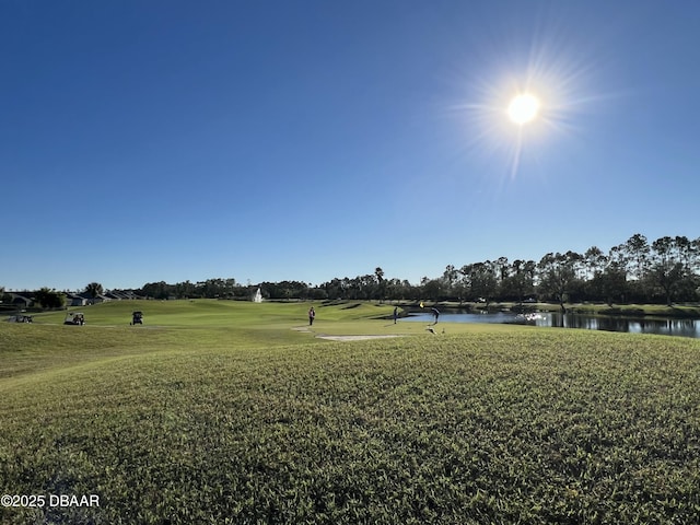 view of property's community featuring a water view and a yard