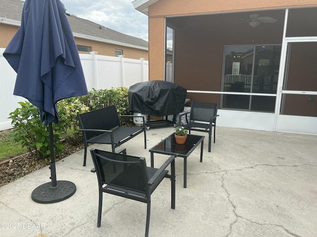 view of patio / terrace with a sunroom, ceiling fan, and grilling area