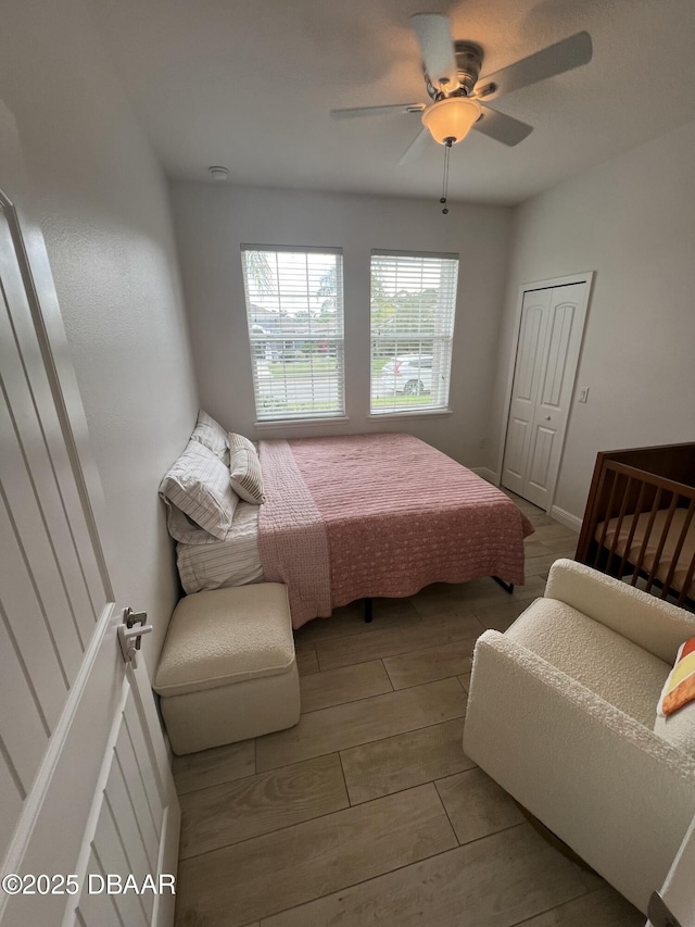 bedroom featuring ceiling fan, light hardwood / wood-style floors, and a closet