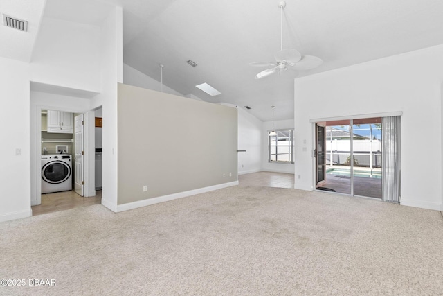 7 Sea Park Ter, Ormond Beach, FL 32176 - unfurnished living room featuring washer / clothes dryer, visible vents, a ceiling fan, high vaulted ceiling, and light colored carpet