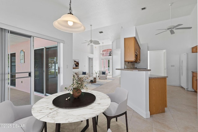 7 Sea Park Ter, Ormond Beach, FL 32176 - dining room with light tile patterned floors, a towering ceiling, visible vents, and a ceiling fan