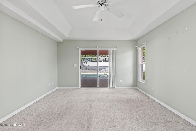 7 Sea Park Ter, Ormond Beach, FL 32176 - empty room with a tray ceiling, baseboards, and carpet
