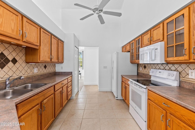 7 Sea Park Ter, Ormond Beach, FL 32176 - kitchen featuring a sink, brown cabinetry, tasteful backsplash, and white appliances