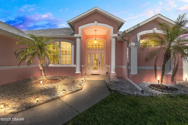 7 Sea Park Ter, Ormond Beach, FL 32176 - exterior entry at dusk featuring french doors and stucco siding