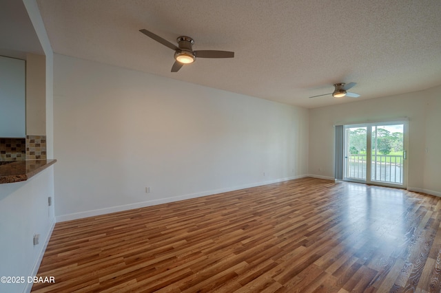 66 Rivers Edge Ln Unit 66, Palm Coast, FL 32137 - unfurnished living room with a ceiling fan, wood finished floors, and a textured ceiling