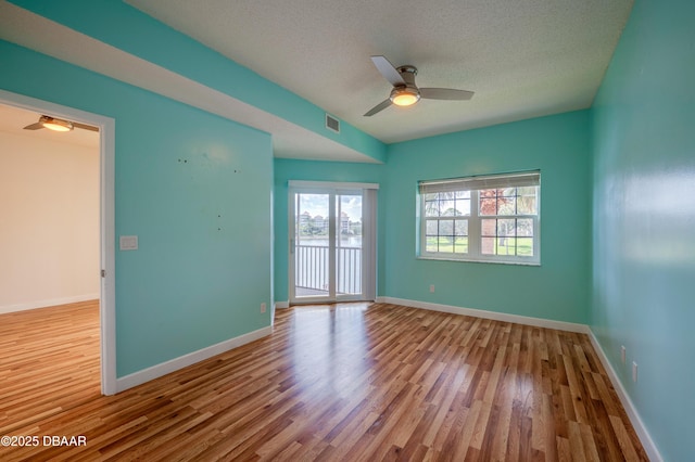 66 Rivers Edge Ln Unit 66, Palm Coast, FL 32137 - empty room featuring wood finished floors, a ceiling fan, and a textured ceiling