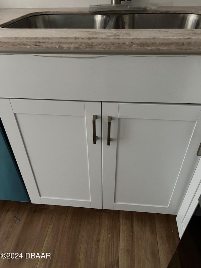 room details featuring dark hardwood / wood-style flooring and white cabinets