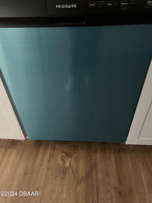 interior details featuring hardwood / wood-style floors and stainless steel dishwasher