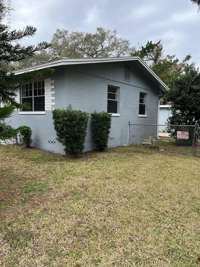 view of side of property with a yard